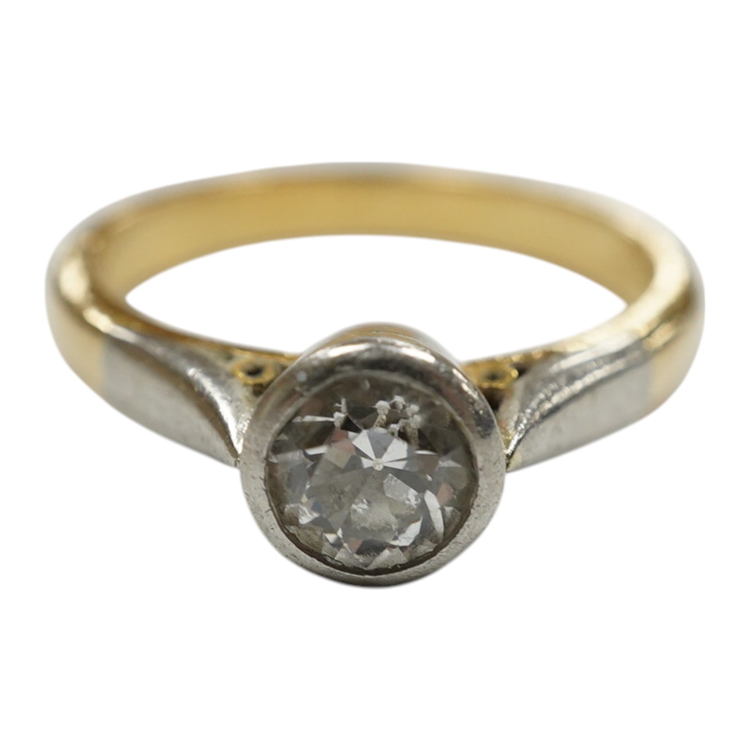 A yellow metal and collet set solitaire diamond set ring, size J/K, gross weight 4.2 grams. Condition - fair